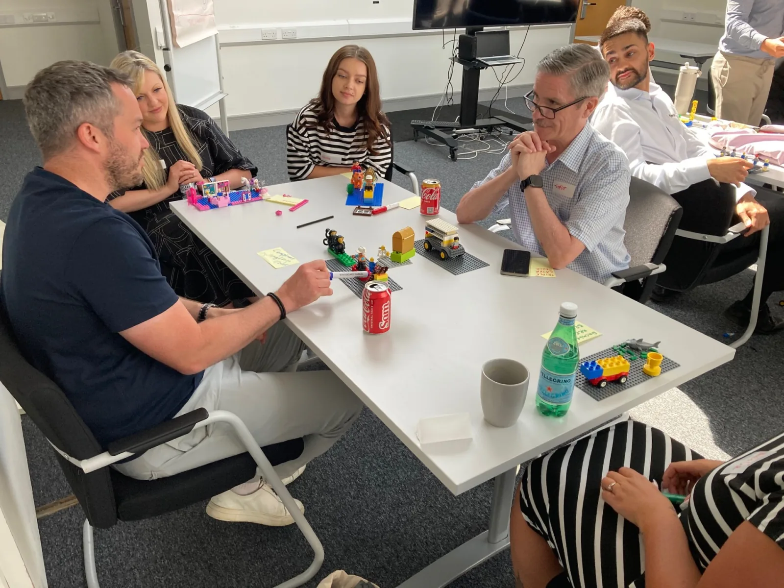 Dachser colleagues discussing their LEGO® models during a workshop
