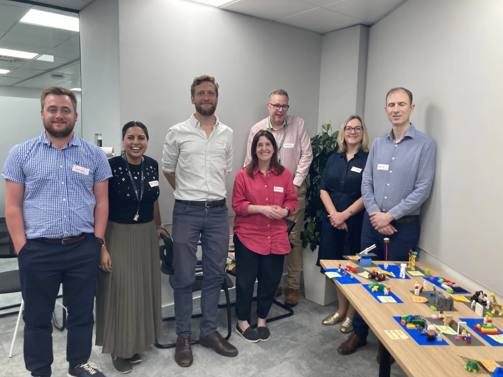 Finlays workshop team standing beside their completed LEGO® models