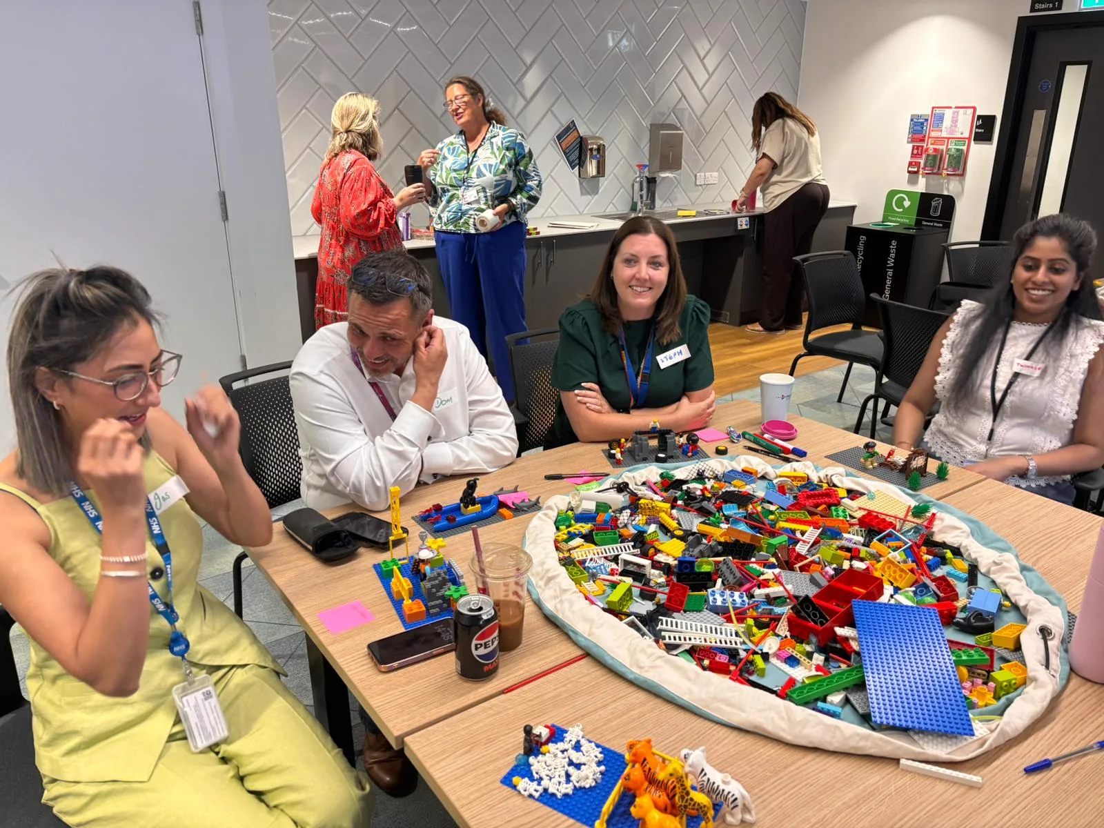 NHS England workshop participants using LEGO® Serious Play® around a table